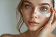 © Sara_P - A beautiful young woman gently applying facial cream,with healthy skin and facial care, Cosmetic cream,dermatology