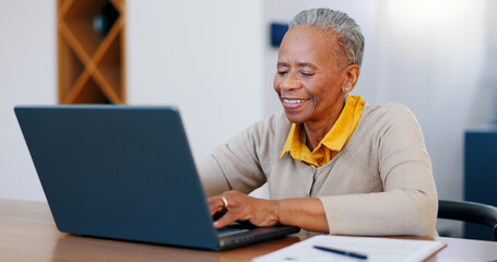 Happy senior woman, laptop and typing in finance with documents for bills or expenses in remote work at home. Mature African female person or freelancer smile on computer in financial budget at house