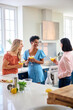 © Monkey Business - Three Mature Female Friends At Home Having Fun Mixing And Drinking Cocktails Together