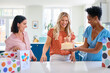 © Monkey Business - Three Mature Women Meeting At Home To Celebrate Friend's Birthday With Surprise Cake Together