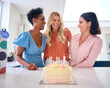 © Monkey Business - Three Mature Women Meeting At Home To Celebrate Friend's Birthday With Surprise Cake Together