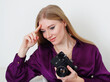 © Olga - beautiful blonde girl sitting with a camera