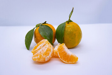 Orange Tangerine Green Citrus Fruit with leaves in isolated white background