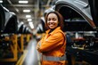 Portrait of a young woman working automotive factory