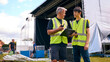 © Monkey Business - Male Production Team With Flight Cases Setting Up Outdoor Stage For Music Festival