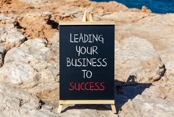 Wall Mural - Leading your business to success symbol. Concept words Leading your business to success on beautiful blackboard. Beautiful stone sea background. Leading your business to success concept. Copy space