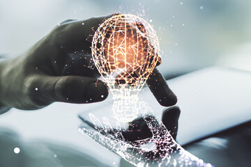 Poster - Creative light bulb hologram and hand working with a digital tablet on background, idea concept. Multiexposure