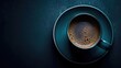  a close up of a cup of coffee on a saucer on a blue table with a black wall in the background.