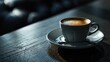  a close up of a cup of coffee on a saucer on a wooden table with a blurry background.