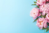 Fototapeta Tulipany - Flat lay of pink peony flowers with copyspace on blue background