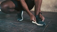Man, Hands And Tie Shoes For Running, Fitness Or Workout Exercise On Outdoor Concrete Floor. Closeup Of African Male Person, Runner Or Athlete Tying Shoe Lace In Preparation For Cardio Training