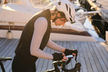 A Woman Cyclist Using Mobile Phone For Navigation Close-up Photo. Bike Computer. Bike Navigator. Cycling Computer.