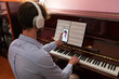 Man Making Remote Music Piano Lesson With Smartphone Conference