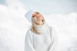 Beautiful blonde girl in the mountains of the Swiss Alps. Winter sunny day, a lot of snow. Resort