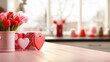 © David - St Valentines Day themed border on kitchen table with Love heart and red tulips and blurred kitchen in the background
