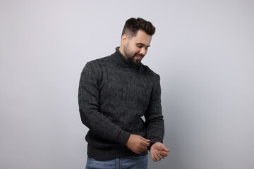 Wall Mural - Happy man in stylish sweater on white background