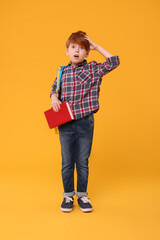 Sticker - Confused schoolboy with backpack and book on orange background