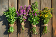 © MNStudio - Hanging bunches of medicinal herbs and flowers on a wooden background. Herbal medicine.