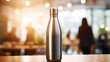 Closeup of a reusable stainless steel water bottle, encouraging people to ditch singleuse plastic bottles.