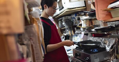 Wall Mural - Pancakes, Japanese chef and man in a kitchen at a stove with cooking, food and brunch at restaurant. Breakfast, hungry and baking for snack, cuisine and morning dining in a diner or cafe with a pan