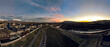 Aerial panorama of a suburb and park at sunset
