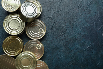 Wall Mural - Assortment of tin cans with fish on dark table