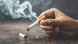 Close-up of hand crushing a burning cigarette, symbolizing determination to quit smoking