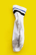 Dirty white socks on yellow background.