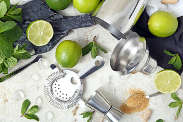 Wall Mural - Measure cup, strainer and ingredients for preparing mojito on light background