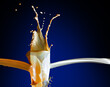Milk coffee splashes from the class on the blue background