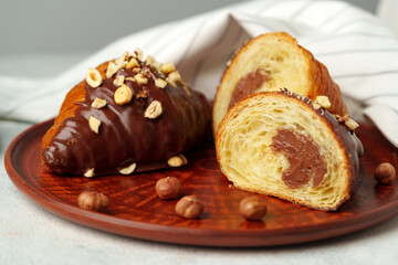 Wall Mural - Glazed croissants on clay plate on table