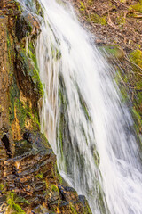 Wall Mural - Splashing water in a waterfall on a rock