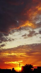 Wall Mural - timelapse with beautiful sunset sky over houses village. vertical video