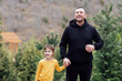 © Dasha Petrenko - Young laughing man holds the hand of little cute girl. Smiling dad together with his sweet daughter in the park.