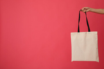 Wall Mural - White bag in hands on a red background