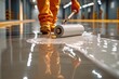 A worker applies a glossy epoxy coating to a concrete floor with a roller, providing a smooth and durable finish in a well-lit industrial environment.