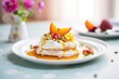 pavlova with a slice of peach and whipped cream