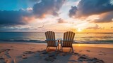 Fototapeta  - Two deck chairs for sunbathing on the beach, view at sunset. beautiful colorful sunset