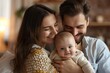 © fledermausstudio - Happy man holding adorable baby near smiling wife