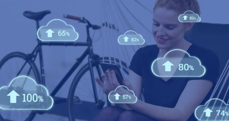 Poster - Animation of cloud icons with growing number over caucasian woman using smartphone