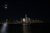 Fototapeta  - Stunning view of the New York City skyline at night, beautifully illuminated by lights