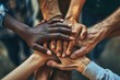 A picture of a group of people joining their hands together in unity. This image can be used to represent teamwork, collaboration, support, friendship, or unity in various contexts