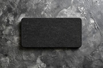 Poster - A black mouse pad placed on a smooth gray surface. Perfect for office and technology-themed designs