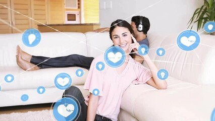 Poster - Animation of network of connected icons in circles over happy biracial couple listening to music