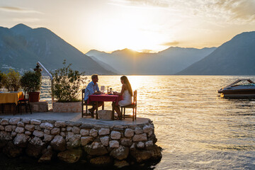 honeymoon couple is having a private, romantic dinner at a tropical beach