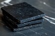 Dark obsidian stone coaster set on a black marble table