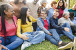 © DisobeyArt - Group of multigenerational people smiling and laughing together - Multiracial friends with different ages having fun outdoor at city park - Main focus on caucasian woman with glasses