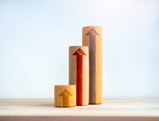 Poster - rising up arrows on round wooden sticks as business graph steps isolated on wood desk on white backg