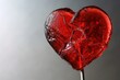 Broken red lollipop heart for Valentines  concept. The idea of unrequited love or divorce