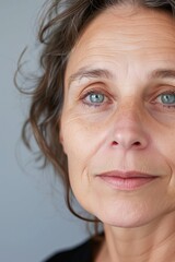 Poster - A close-up shot of a woman's face showcasing her captivating blue eyes. Perfect for beauty and fashion related projects